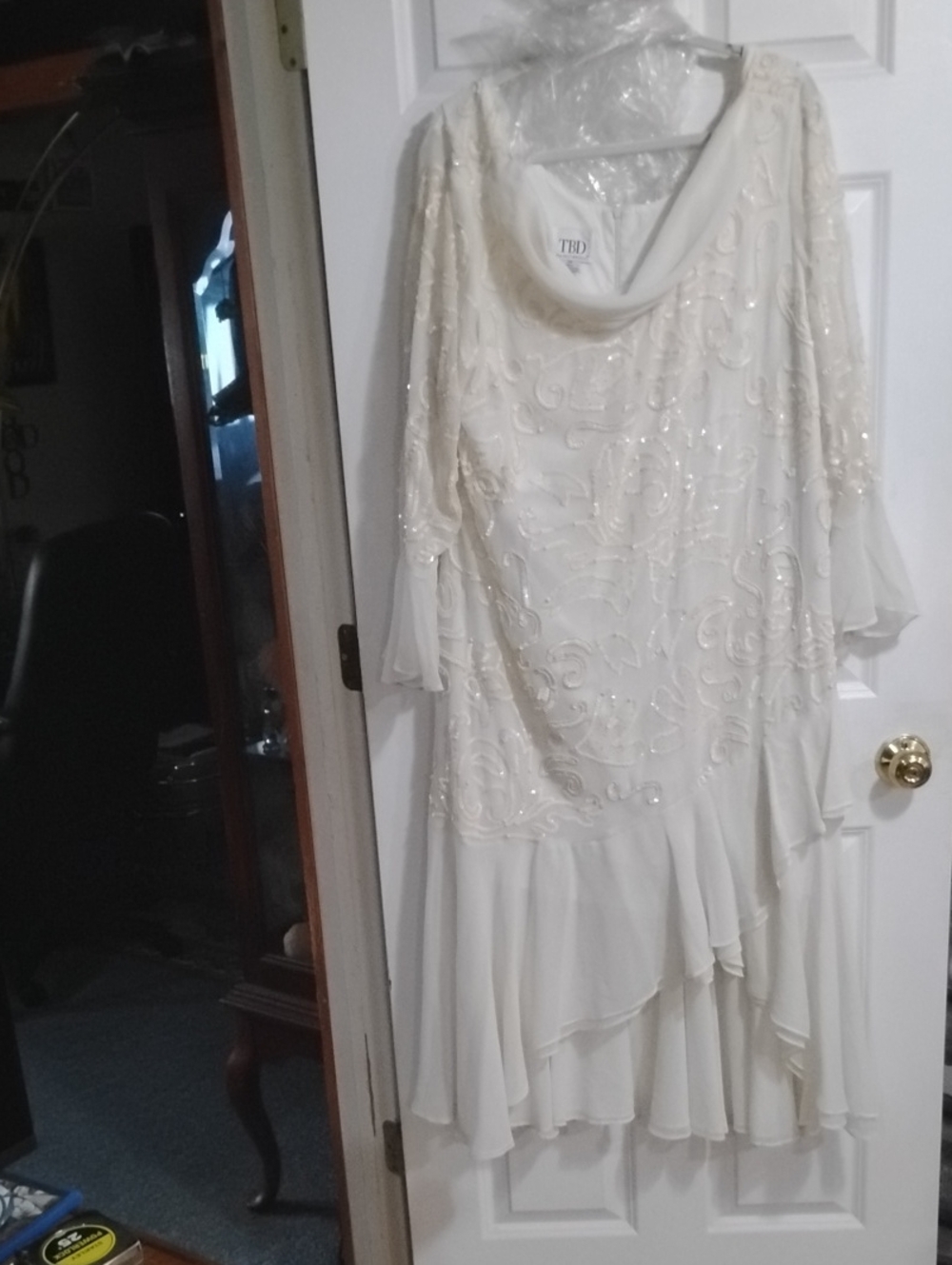 Elegant Ivory Long-Sleeve Beaded Evening Dress with Draped Neckline.